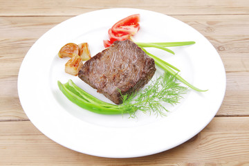 meat food : roasted fillet mignon on white plate with tomatoesan