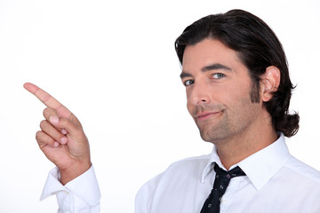 Cheeful businessman pointing