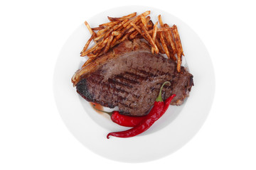 beef steak with potato chips and dry red hot chili peppers