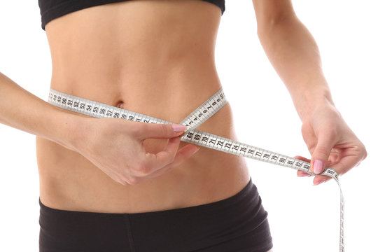 woman measure her waist belly by metre-stick.