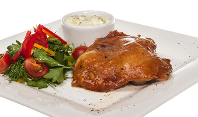 roasted chicken with vegetables on a white plate