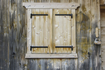 Fototapeta na wymiar Okno na drewnianej chaty w północnych Włoszech