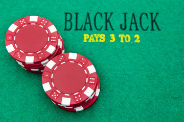 black jack table with red casino chips