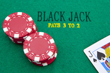black jack with red poker chips in the background.