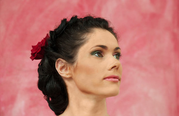 Portrait of brunette woman on a pink background