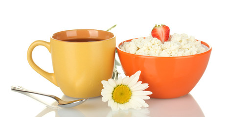 cottage cheese with strawberry in orange bowl and orange cup