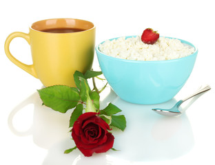 cottage cheese with strawberry in blue bowl and orange cup with
