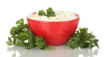 cottage cheese with parsley and dill in red bowl isolated