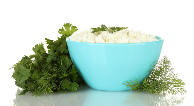 cottage cheese with greenery in blue bowl isolated on white