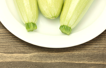 squash in a white plate on wooden table close-up