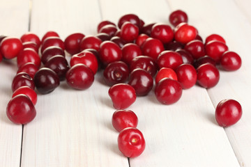 fresh cherry on white wooden table close-up