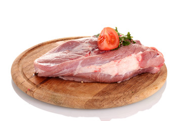 Raw meat with tomato on a wooden board isolated on white