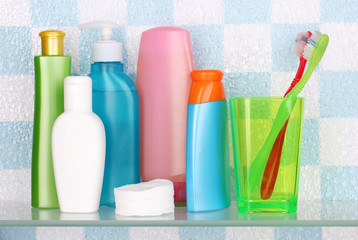 Shelf with cosmetics and toiletries in bathroom