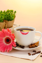 cup of coffee with lipstick mark and gerbera beans, cinnamon