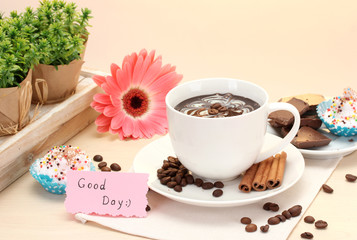 cup of coffee and gerbera  beans, cinnamon sticks