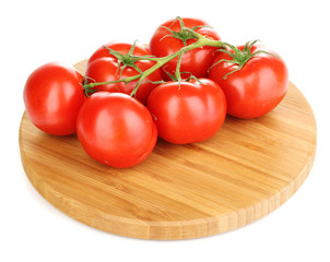 Fresh tomatoes on wooden board isolated on white