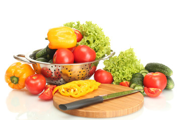 fresh vegetables and knife on cutting board isolated on white