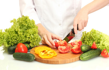 woman hands cutting vegetables on kitchen blackboard