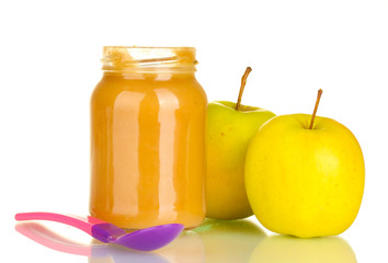 Jar with apple baby food and spoon isolated on white