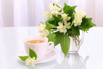 Cup of tea and jasmine flowers