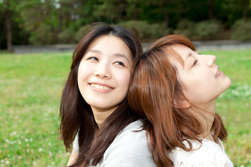 Beautiful young woman in the park. Portrait of asian.