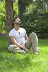 Naklejka na ściany i meble man enjoying the sun during a break