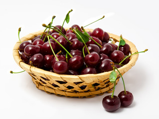 Basket with ripe wet cherry isolated