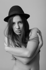 Black and white fashion portrait of beautiful woman with hat