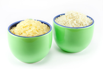 Two varieties of rice inside two cups of coffee
