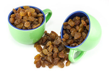 Two coffee cups full of raisins
