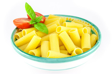 Bowl full of rigatoni pasta with tomatoes and basil