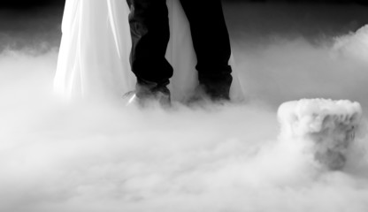 Bride and groom dancing in smoke