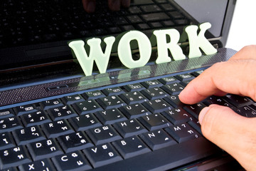 Close-up of male hand before touching button of black computer k