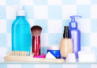 Shelf with cosmetics and toiletries in bathroom