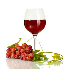 glass of wine and ripe grapes isolated on white