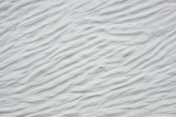 Fototapeta na wymiar wavy pattern stucco white wall