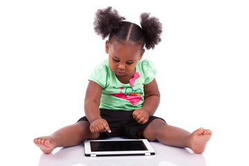 Little african american girl using a tablet pc