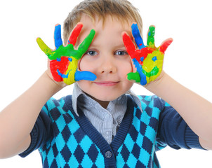 smiling boy with the palms painted by a paint.