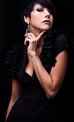 Beautiful woman on black classical dress pose in studio.