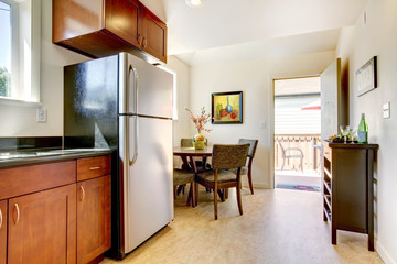 Modern cherry kitchen with steal appliances.