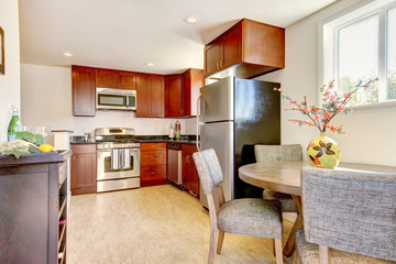 Beautiful cherry kitchen with stain steal apliances.