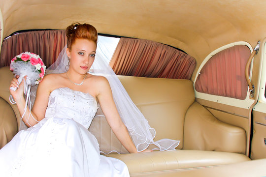 Portrait of the bride sitting in the car