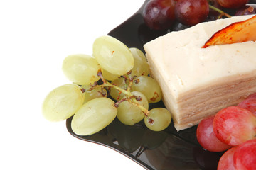 raw grapes and cream cake on black