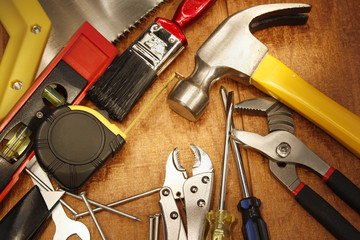 Assorted carpentry work tools on wood