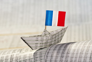 Papierschiff mit französischer Flagge auf Börsennachrichten