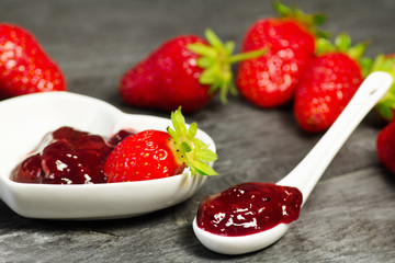 strawberry jam over ceramic spoon