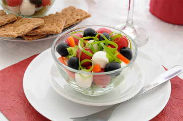 Salad of lettuce, cherry tomatoes, olives and mozzarella with pe