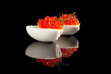 Luxury food. Caviar in eggs with dill.