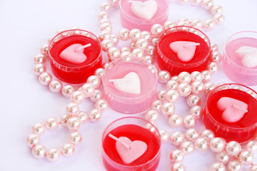 Red and pink candles with necklace