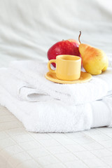 Fototapeta na wymiar cup of tea,apple and pear on the bed